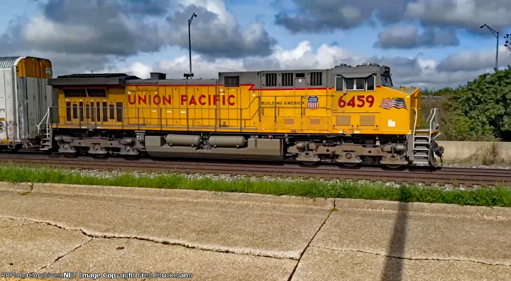 UP 6459 leads the empty piper with a handful of PSR racks.